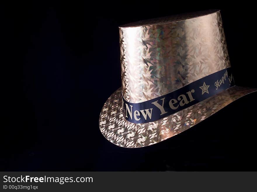 A New Year's Eve party hat taken on a black background.