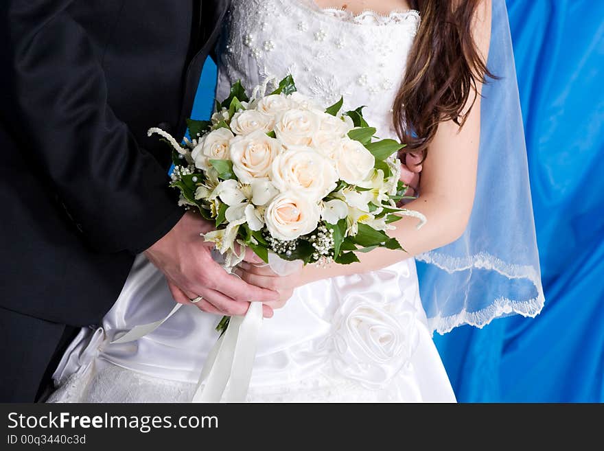 A beautiful white rose bouquet in the hands of the bride and the groom. A beautiful white rose bouquet in the hands of the bride and the groom