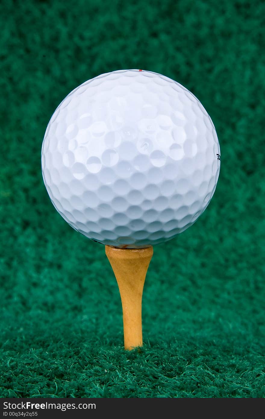 White Golf Ball On Natural Wood Tee