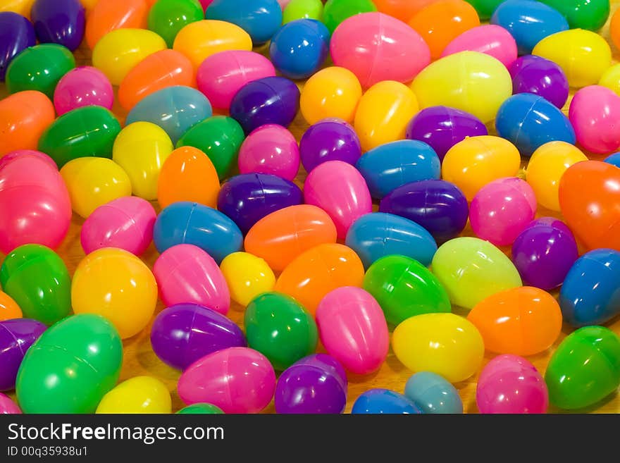 A background of multicolored plastic Easter eggs. A background of multicolored plastic Easter eggs.