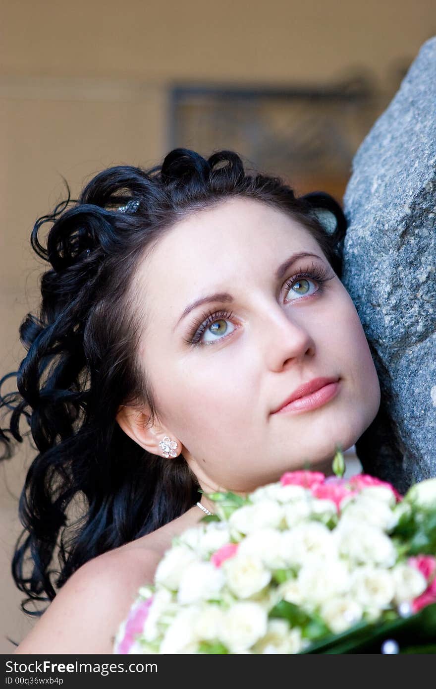 A Girl By The Stone Wall With The Bouquet Of Flowe