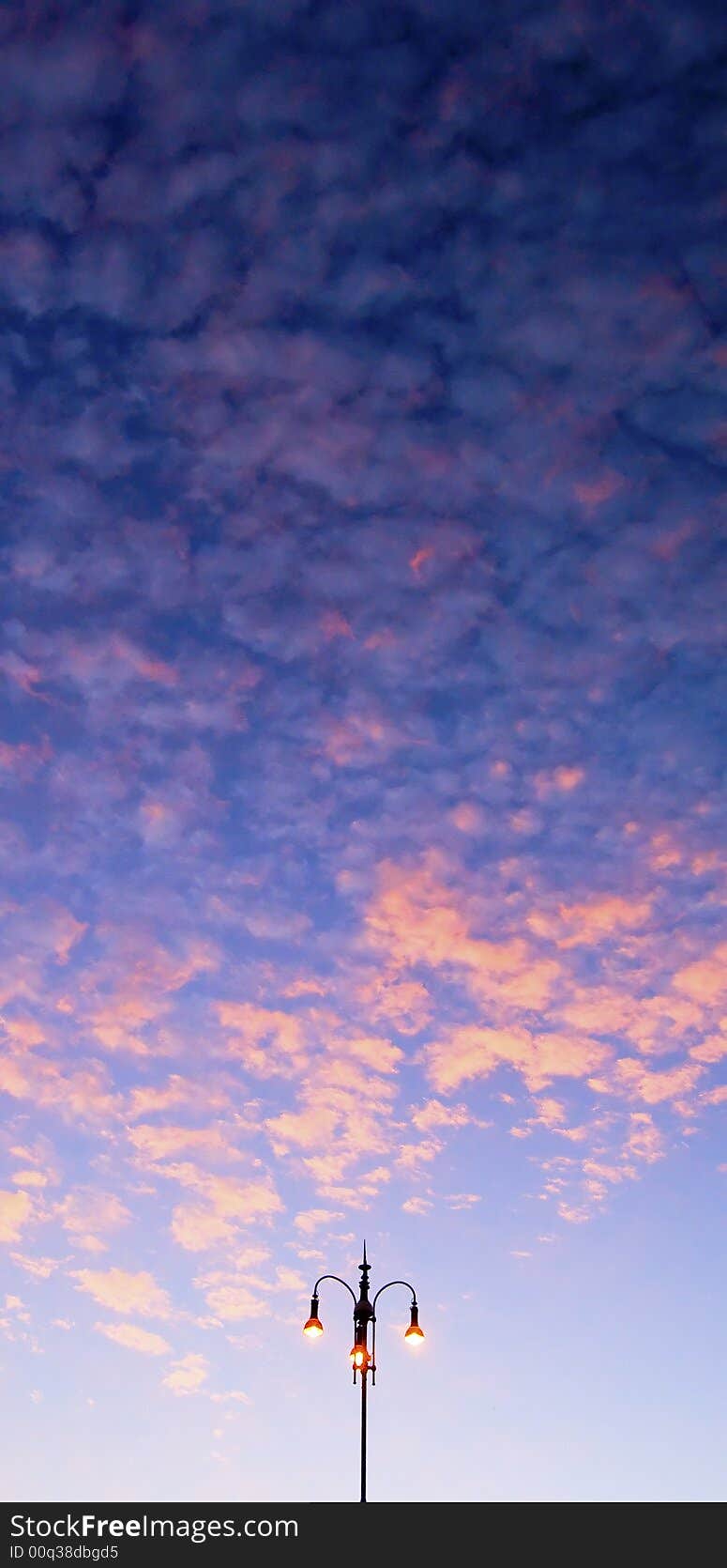 Street lamp lit up during twilight. Street lamp lit up during twilight