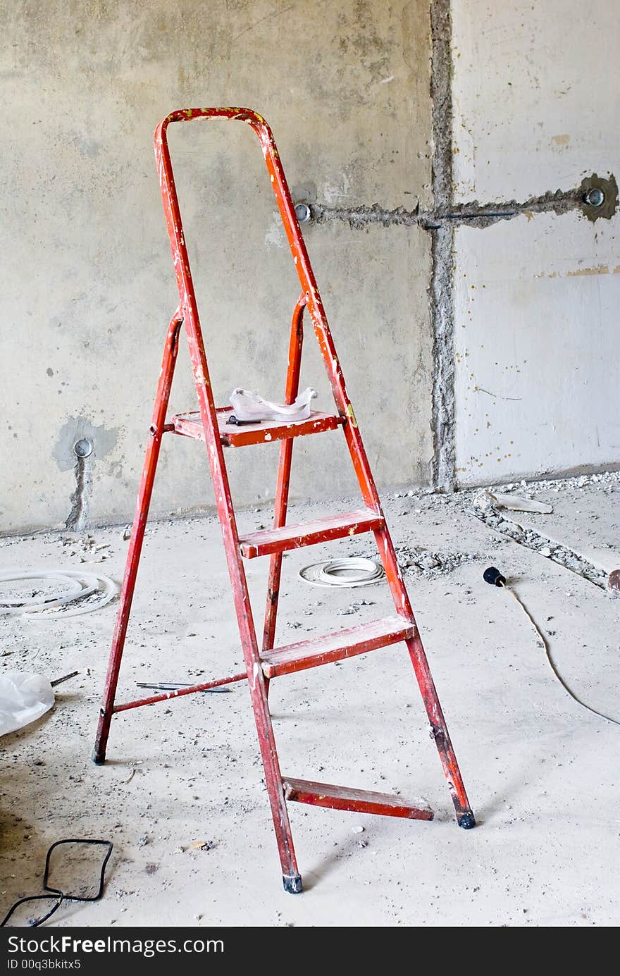 Ladder in messy renovated room