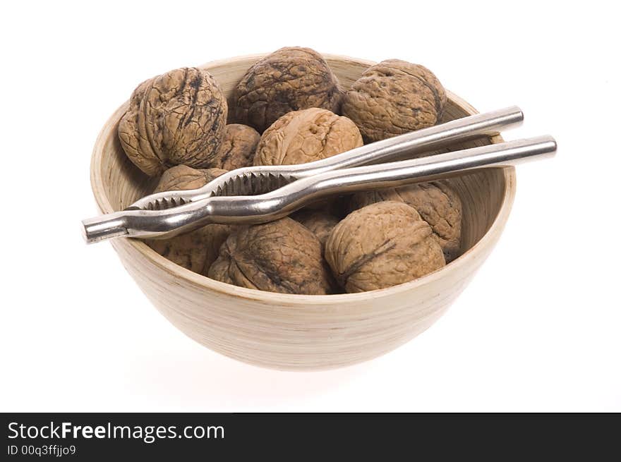 Walnuts and nutcracker isolated on the white background