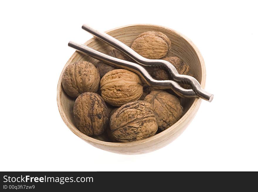 Walnuts and nutcracker isolated on the white background