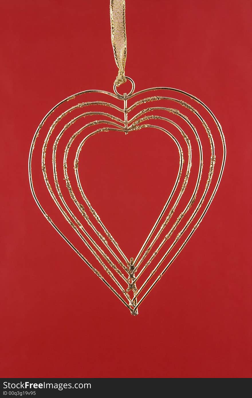 Gold heart on a red background