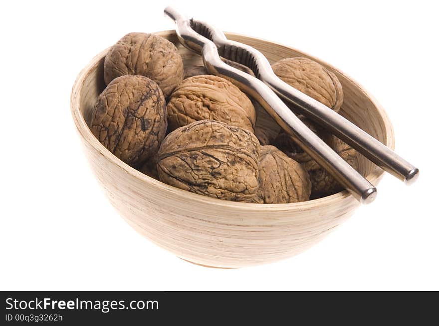 Walnuts and nutcracker isolated on the white background