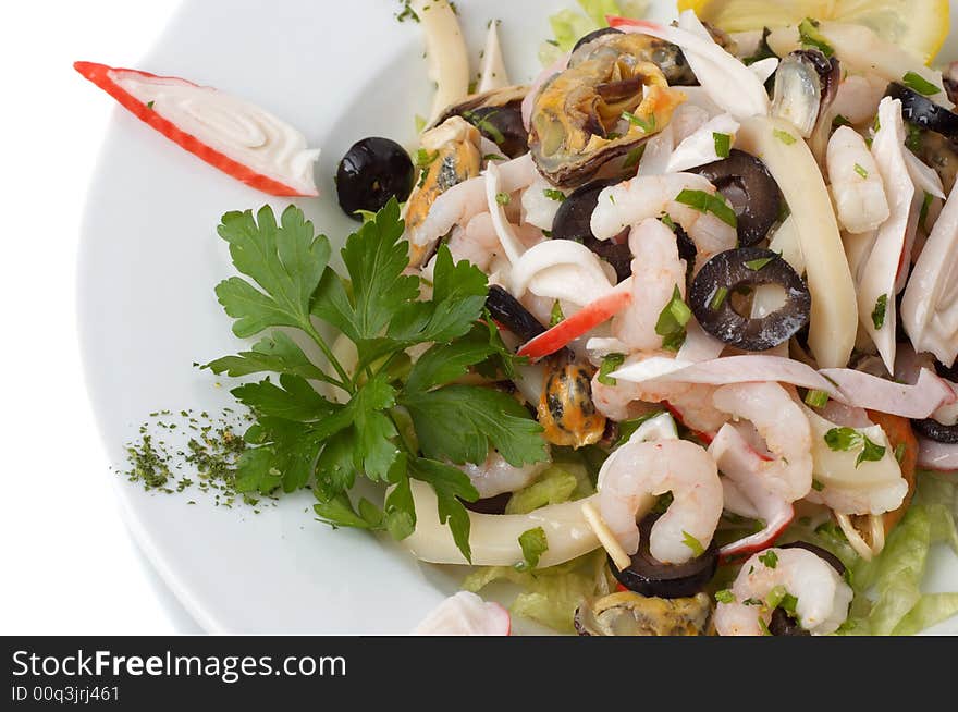 Prepared shrimp and mussel salad with olives, lemon and parsley