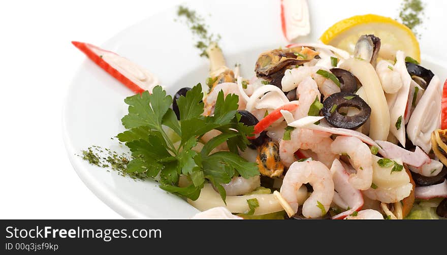 Prepared shrimp and mussel salad with olives, lemon and parsley