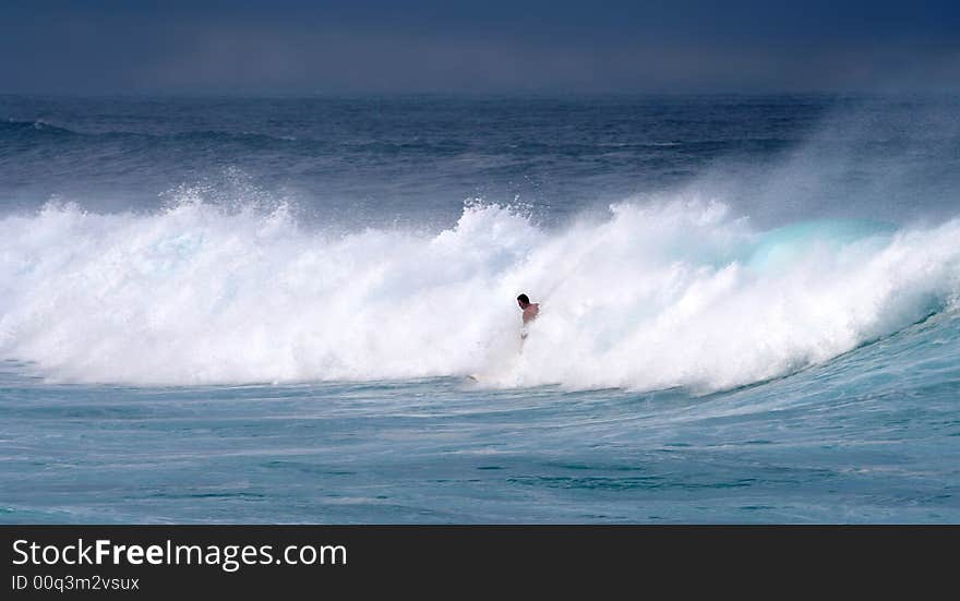 Young surfer in white waves