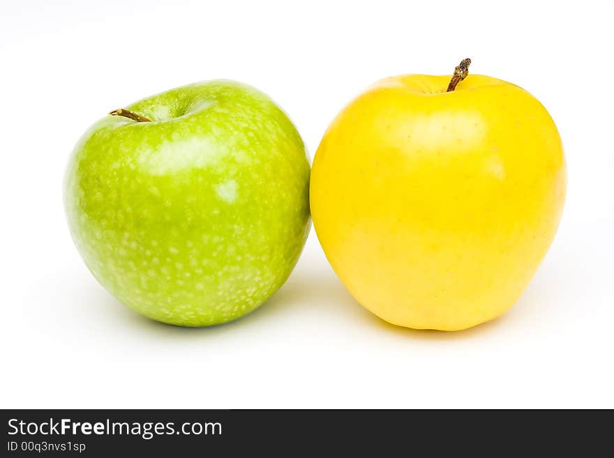 Fresh green and yellow apples at white background