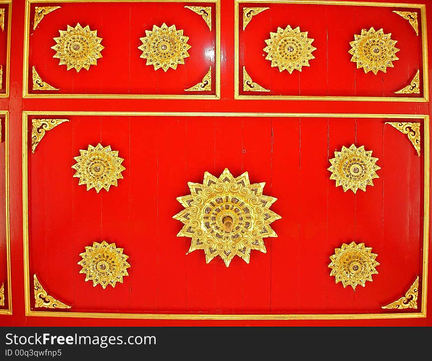 Red wooden background ornately decorated with gold trim. Red wooden background ornately decorated with gold trim