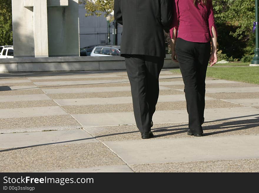 Rear view of businessman and businesswoman walking together towards building. Rear view of businessman and businesswoman walking together towards building