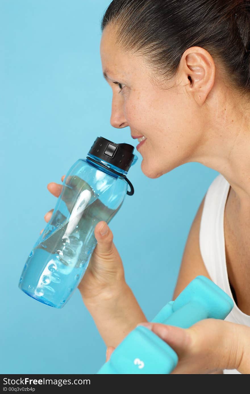 Fit senior woman stopping for a break to get a drink of water. Fit senior woman stopping for a break to get a drink of water