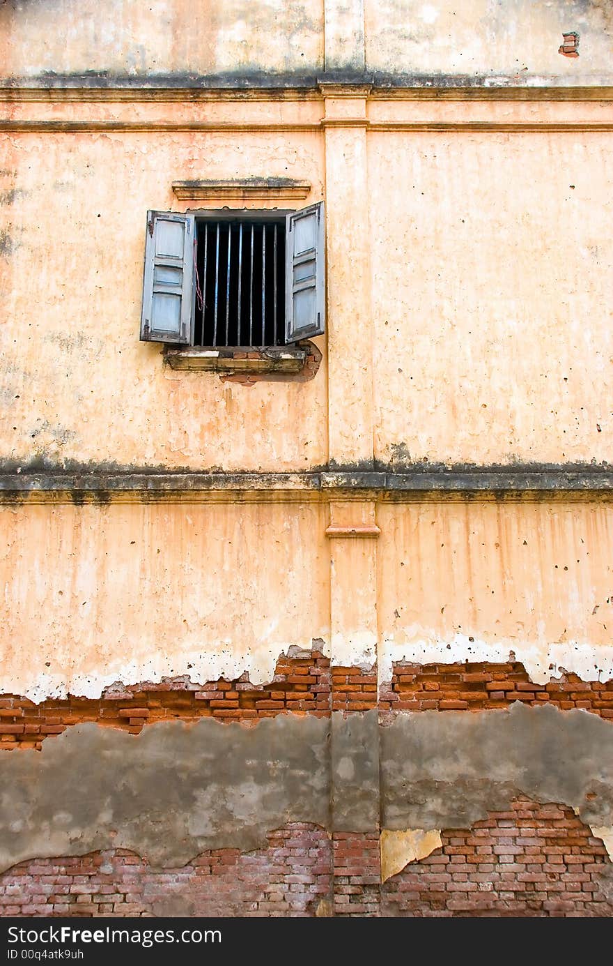 Building with window and decayed wall