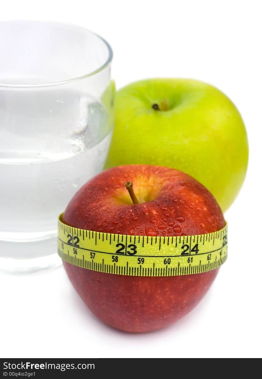 Glass with Water, Green and Red Apple with measuring tape