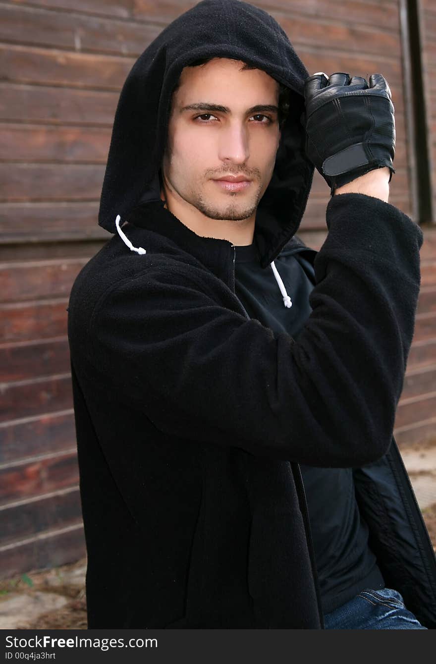 Young man in a fashion pose outdoors