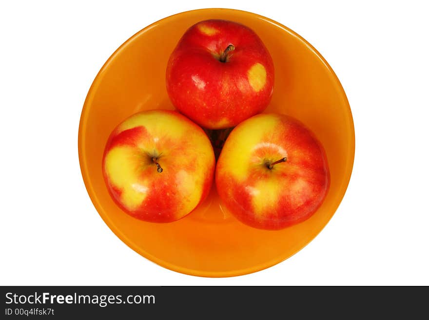 Three fresh apples in a plate on a white background