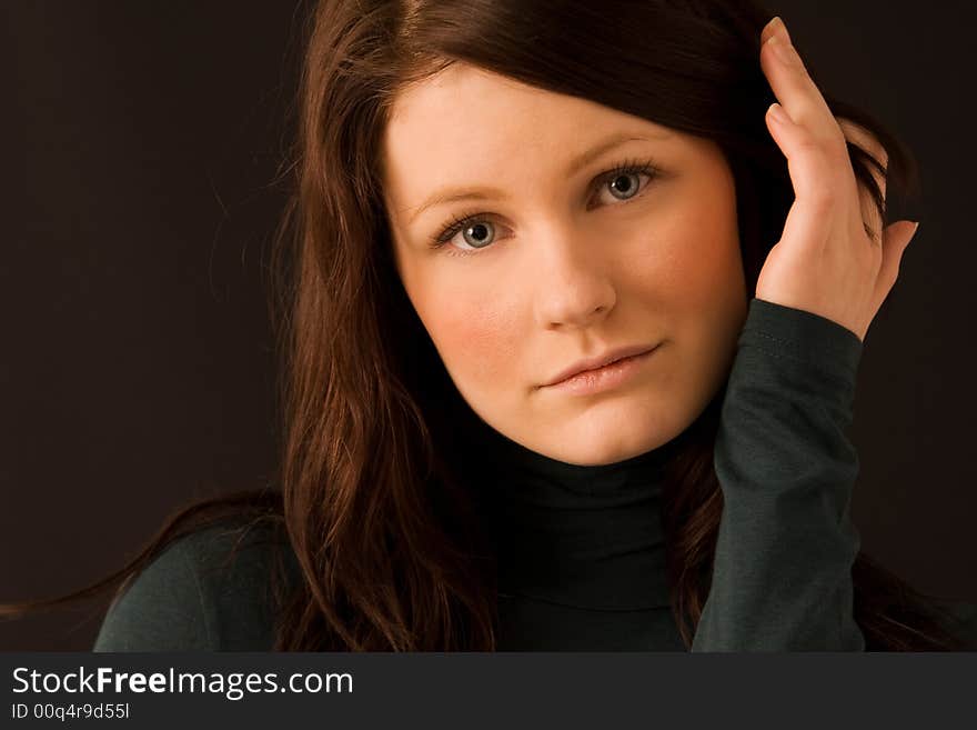 Portrait of young beautiful woman on black background