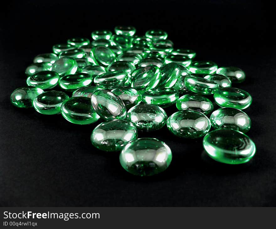 Green shiny stones isolated on black background