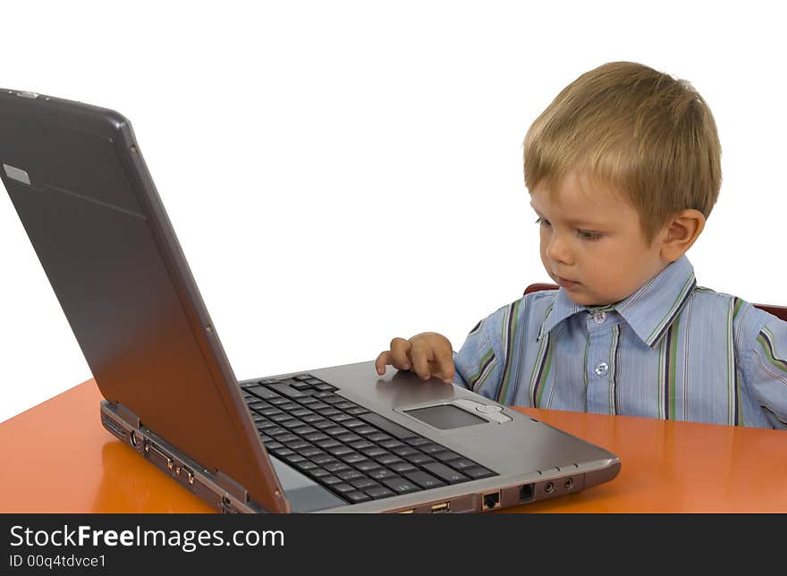 A child works with a laptop. A child works with a laptop.