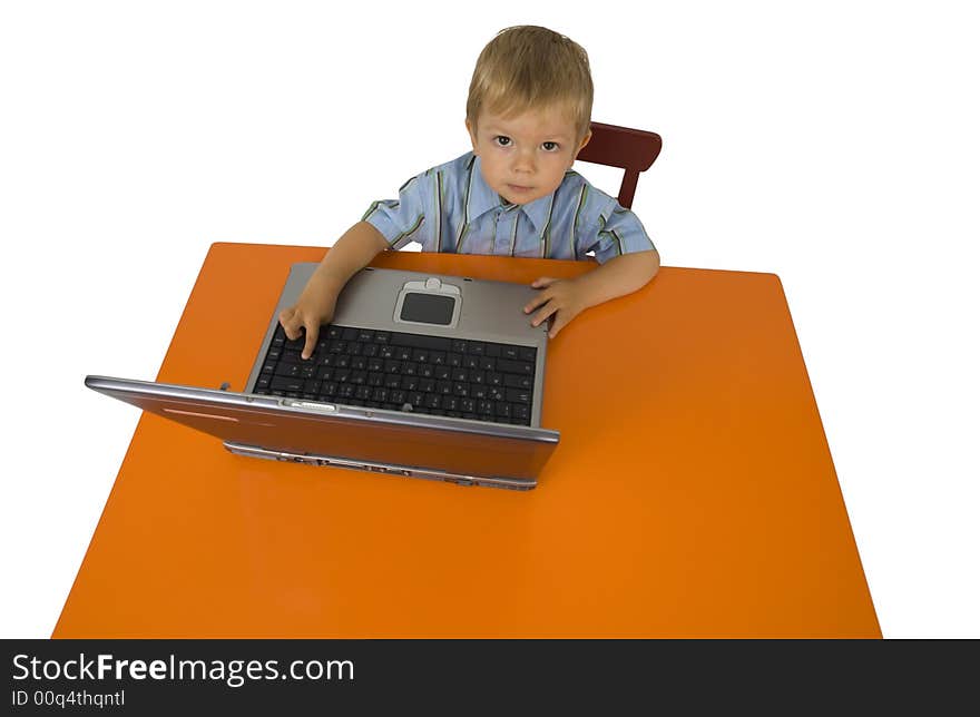 A child works with a laptop. A child works with a laptop.