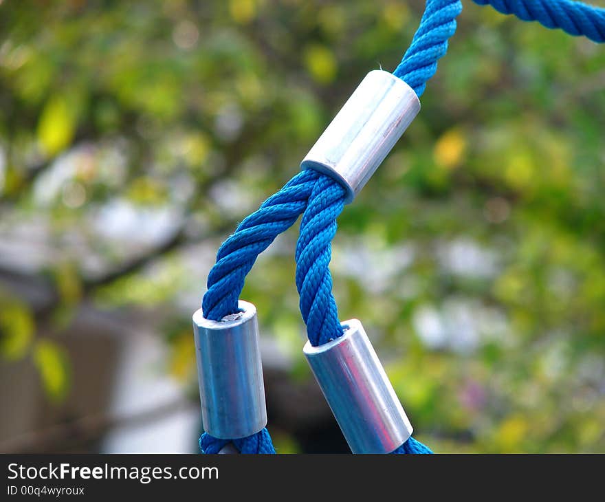 A closeup of a rope that holds a large playground structure together. Depicts a verse in the bible Ecclesiastes 4:12 which says: Though one may be overpowered, two can defend themselves. A cord of three strands is not quickly broken