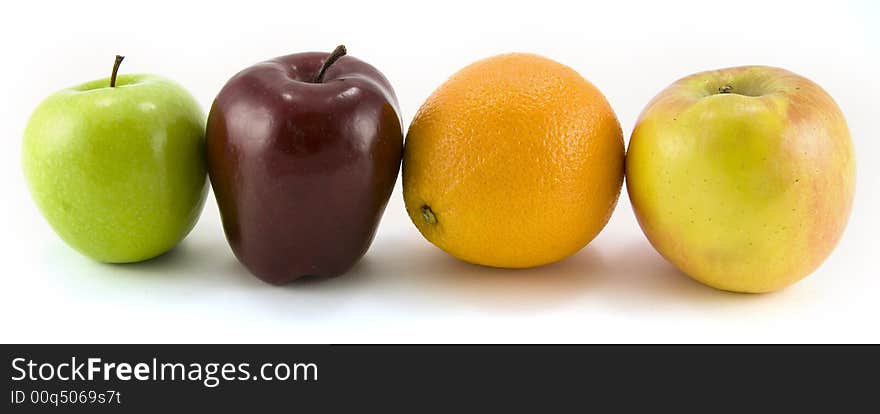 A Granny Smith, Fuji, Red Delicious apples and navel orange isolated on white background. A Granny Smith, Fuji, Red Delicious apples and navel orange isolated on white background.