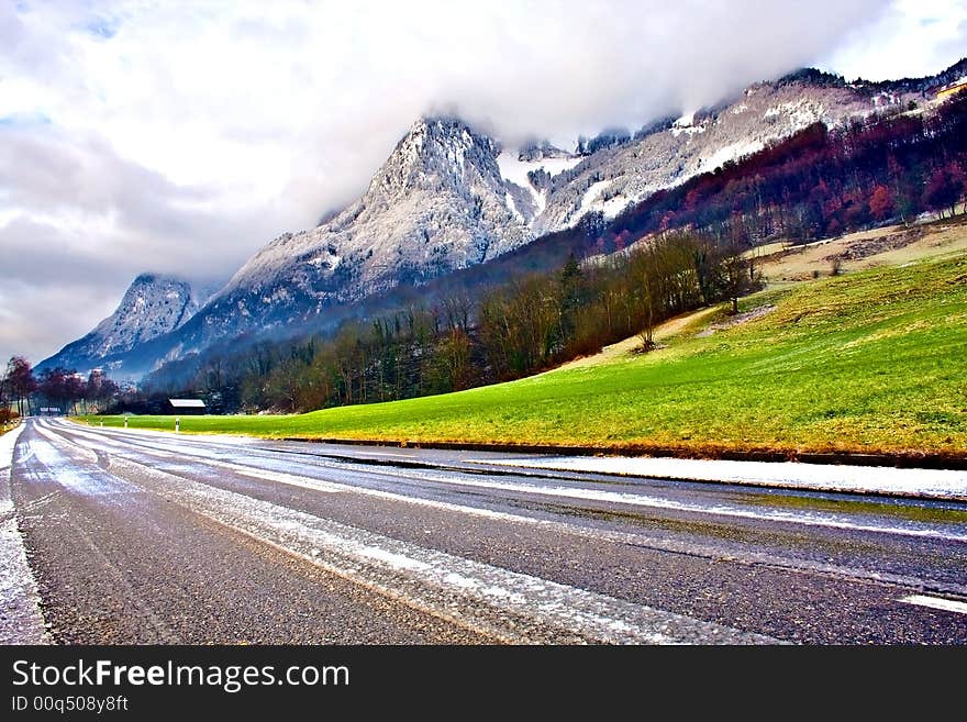 Road under foggy mountains. Switzerland. Road under foggy mountains. Switzerland