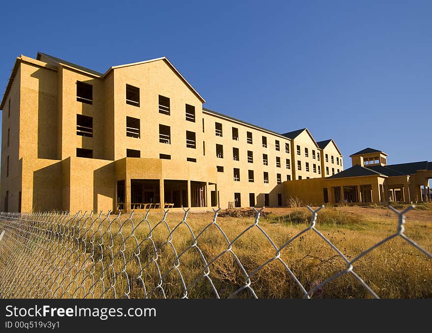 A commercial construction zone for apartments or a hotel against a blue sky background