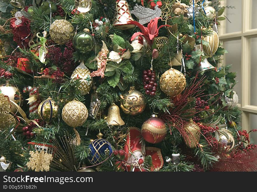 Gold ornaments on a christmas tree in the home