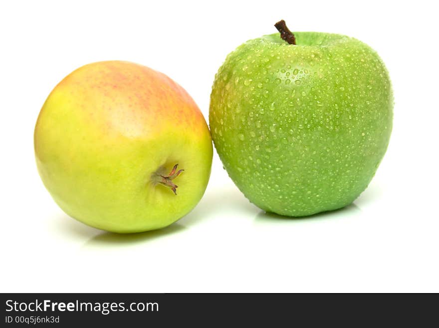 Green and yellow apples on white. Shallow DOF. Green and yellow apples on white. Shallow DOF.