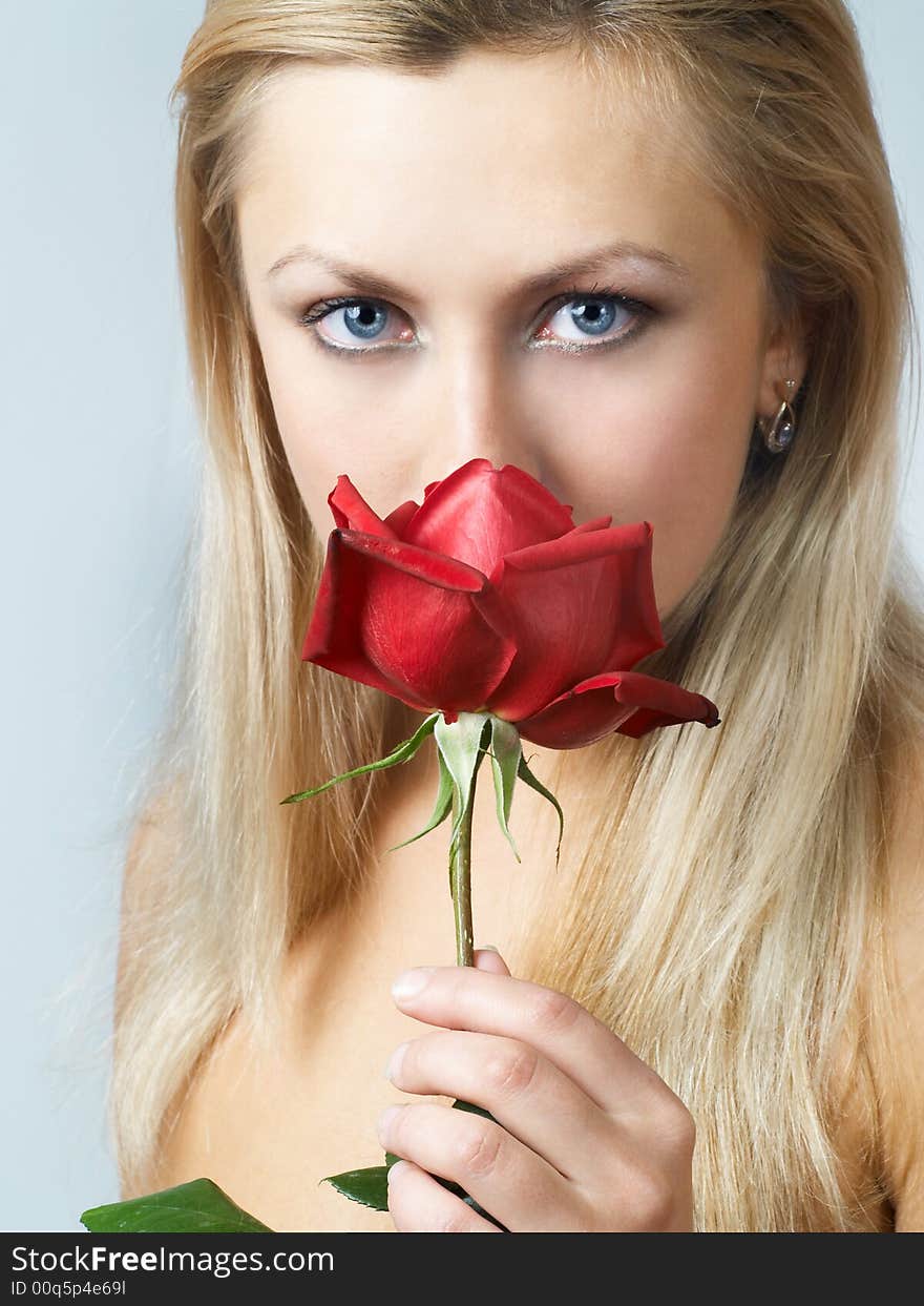 Blonde girl with blood red rose in hands. Blonde girl with blood red rose in hands