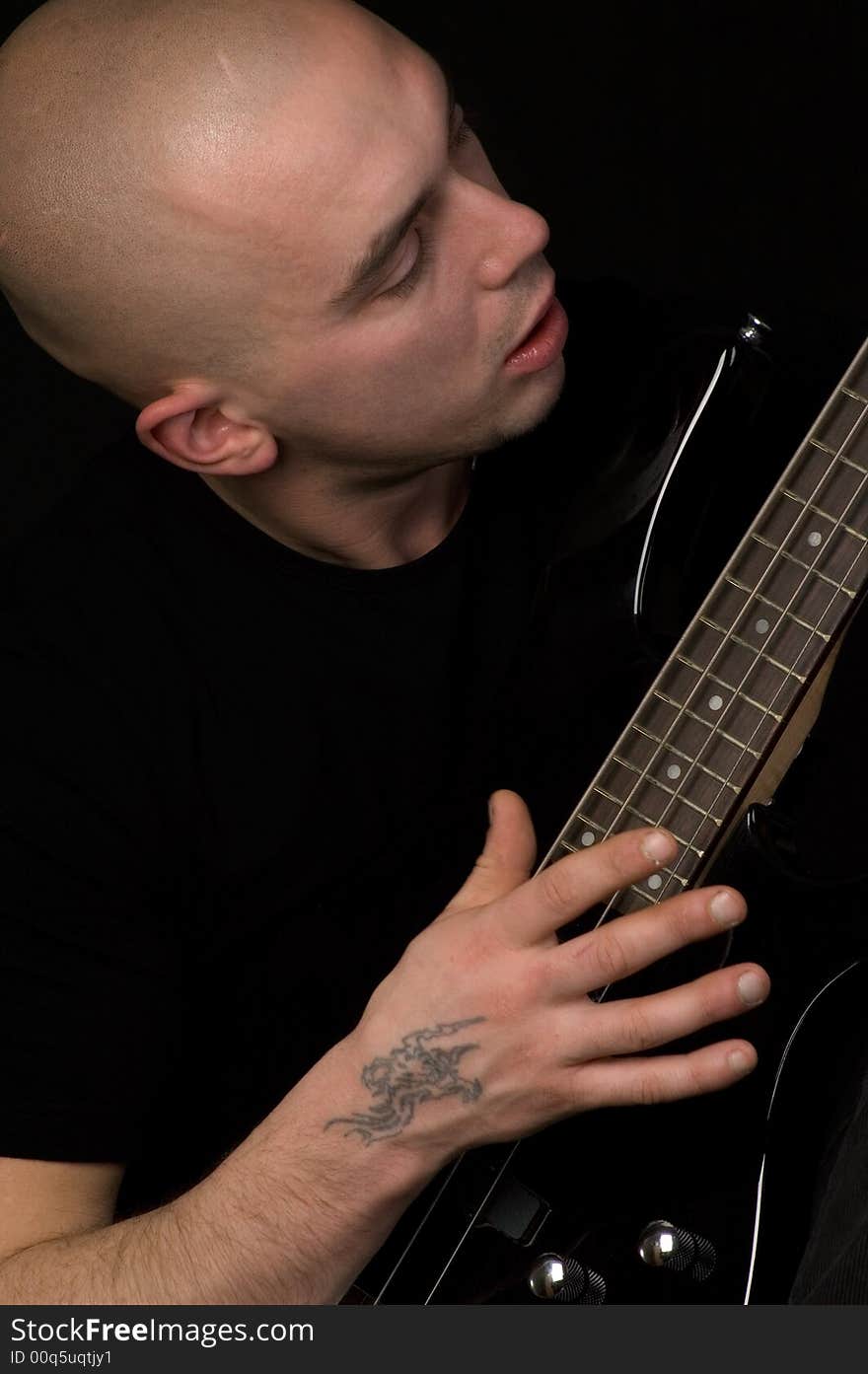 Portrait of the guitarist on a black background. Portrait of the guitarist on a black background