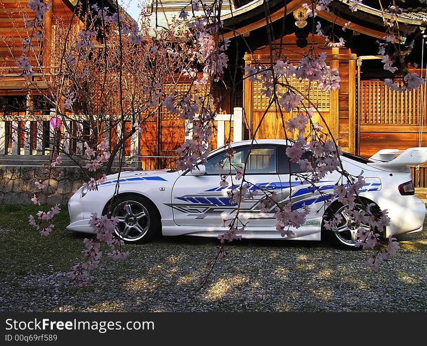 The modern car is near the buddhist temple on sunset. The modern car is near the buddhist temple on sunset