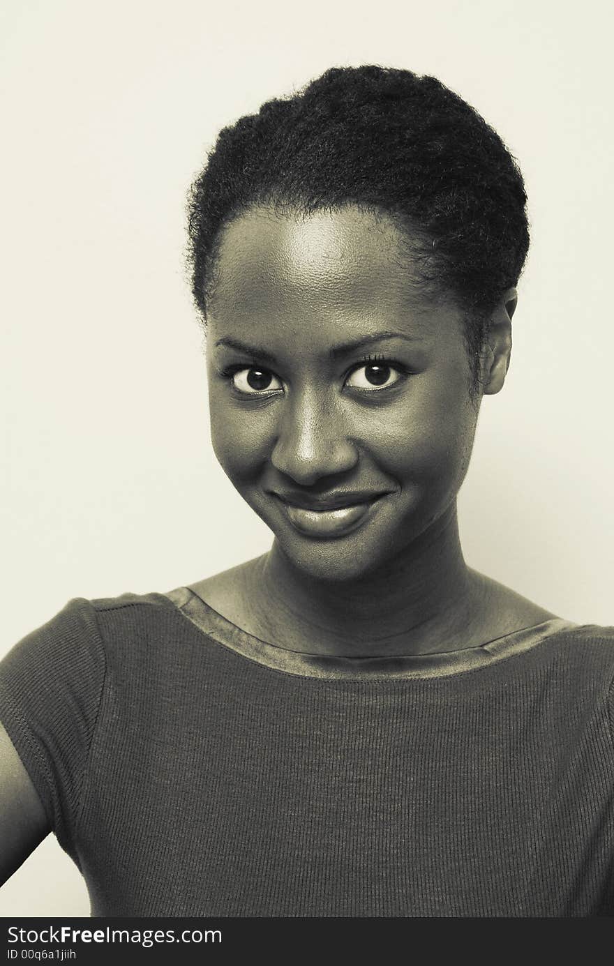 African American woman with a large sweet smile. This image is a yellow toned black and white image. African American woman with a large sweet smile. This image is a yellow toned black and white image.