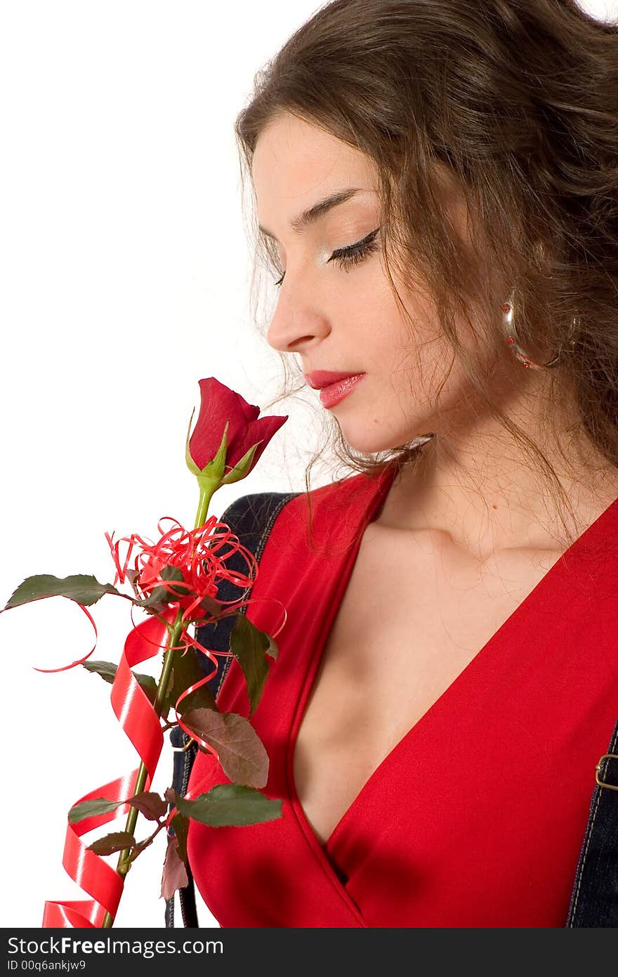 Attractive young woman in red holding red rose - love/valentine concept. Attractive young woman in red holding red rose - love/valentine concept