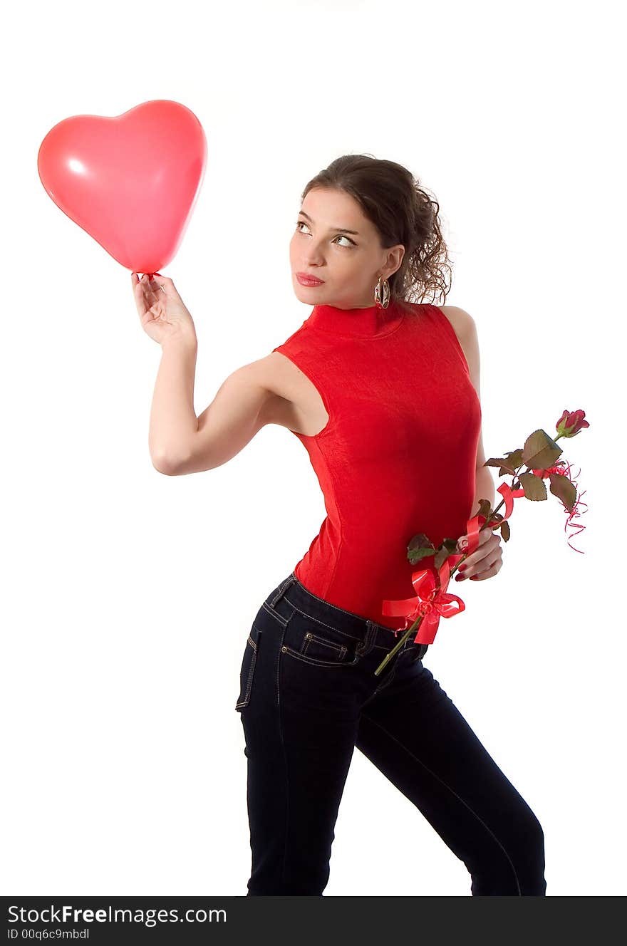 Attractive young woman holding heart shape balloon and a rose - love concept. Attractive young woman holding heart shape balloon and a rose - love concept
