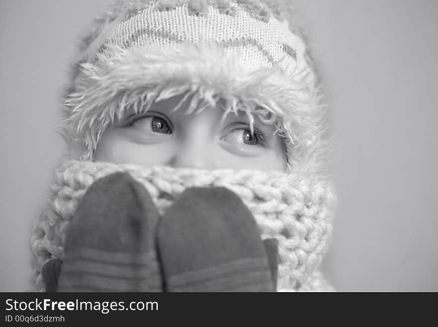 An image of a nice girl in a cap and mittens. An image of a nice girl in a cap and mittens