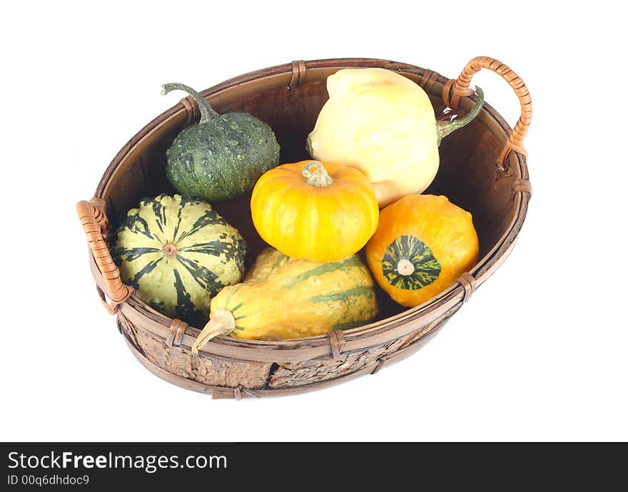 Mini pumpkins in a basket- yellow and green