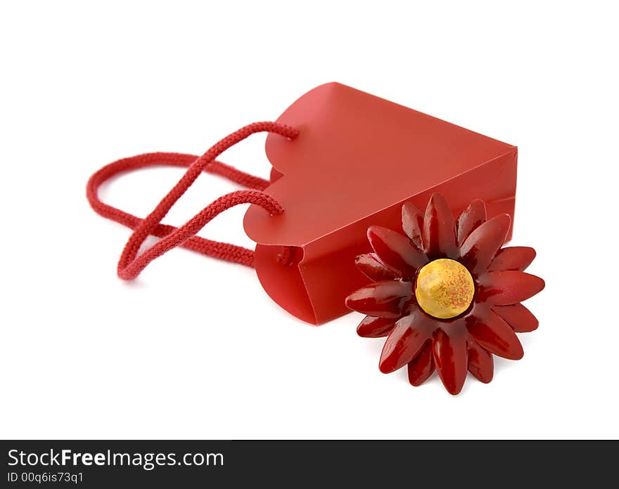 Gift consisting of red bag and flower metal