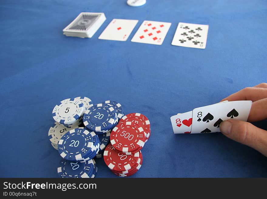 A poker player holds a pair of eights in his hand