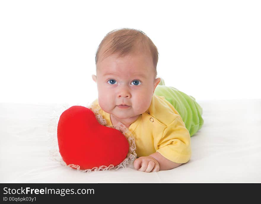 Baby with a soft toy in the form of heart over white