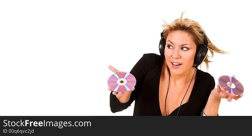 Beautiful young woman listening music in headphones and holding two CD