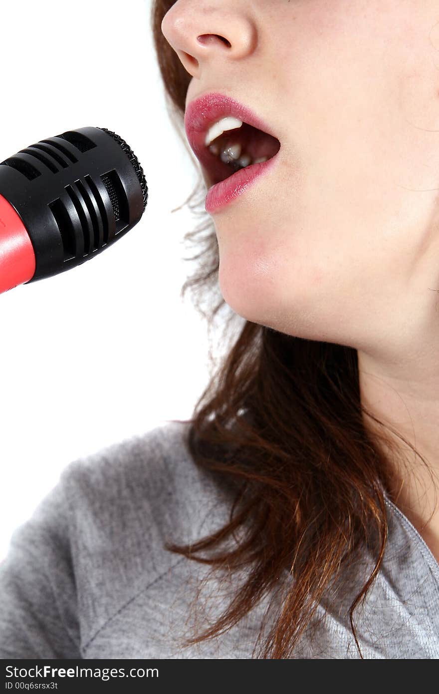 An isolated studio shot of young singer - using a microphone. An isolated studio shot of young singer - using a microphone.