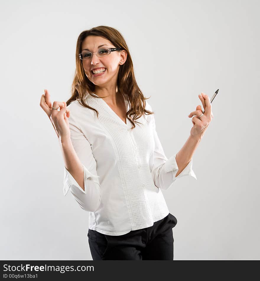 Woman with fingers crossed and a big grin - she hopes to win. Funny pose!