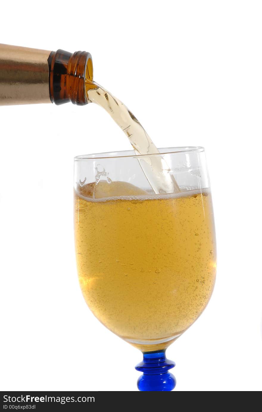 Bottle of cold beer filling the glass on white