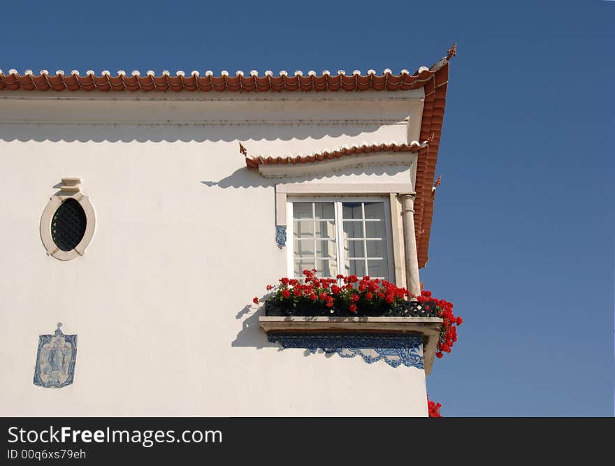 Medieval Building With Window And Flowers