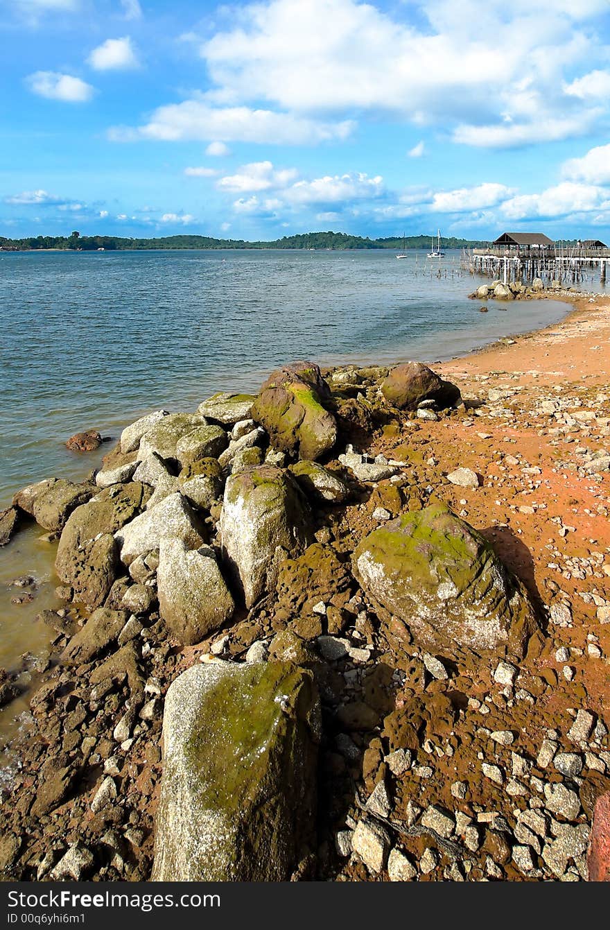 Rocky shore seen from boardwalk in a late afternoon sky