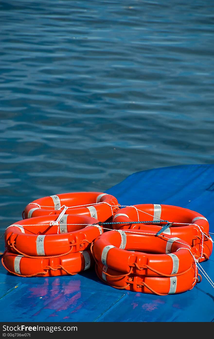 Red lifesaver rings on a blue boat. Red lifesaver rings on a blue boat